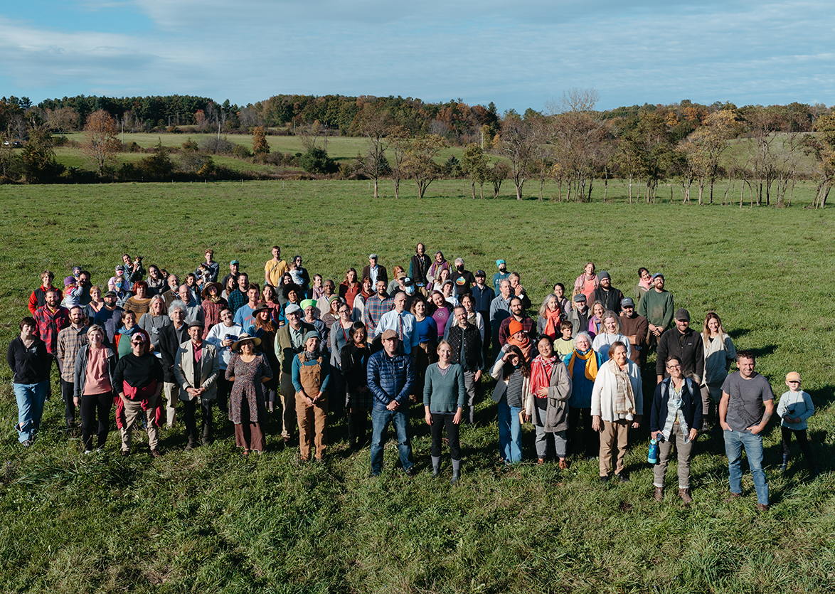 Group photo of Hawthorne Valley staff outside in one of the fields taken at our 50th anniversary